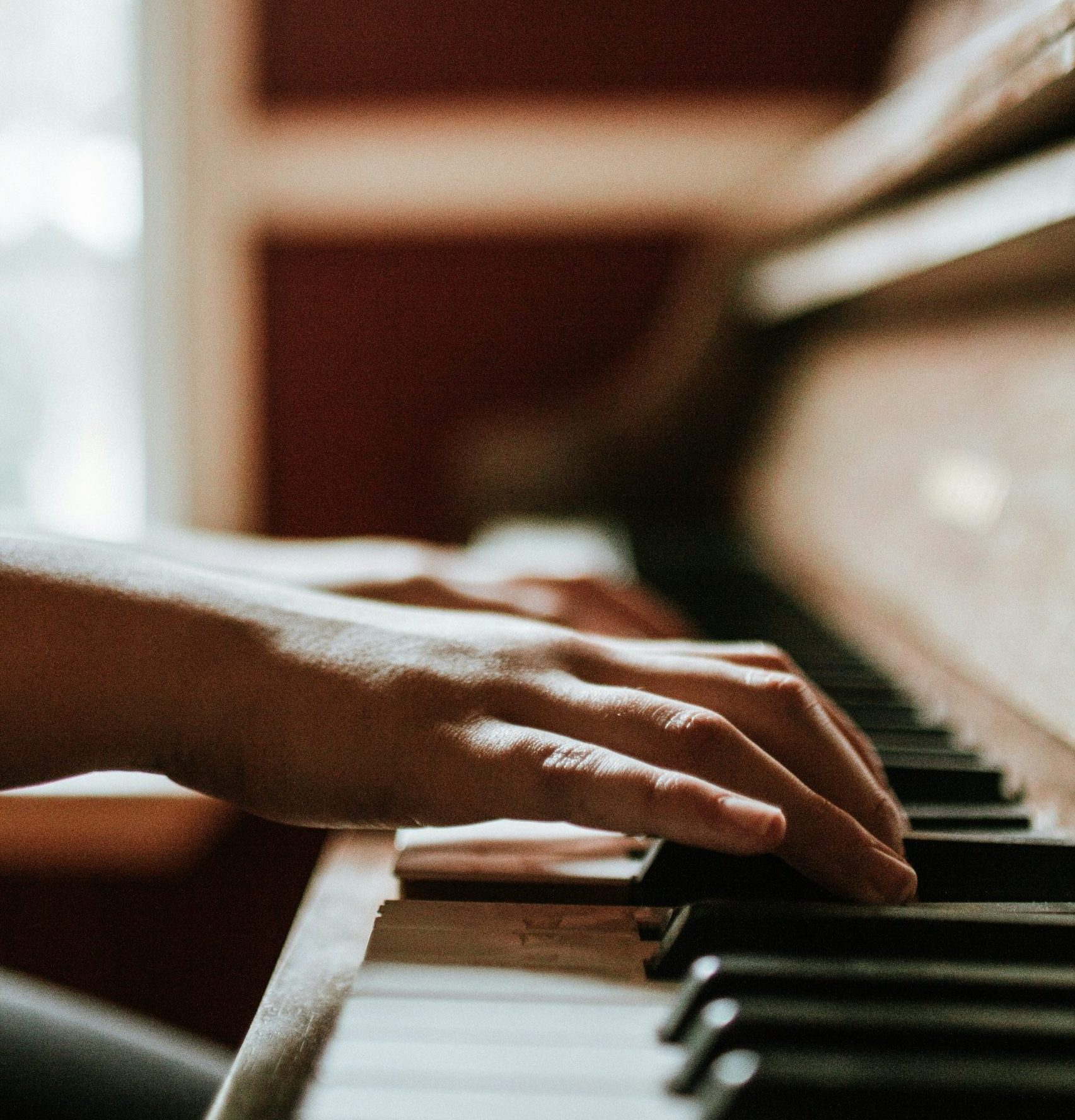 hands playing a piano